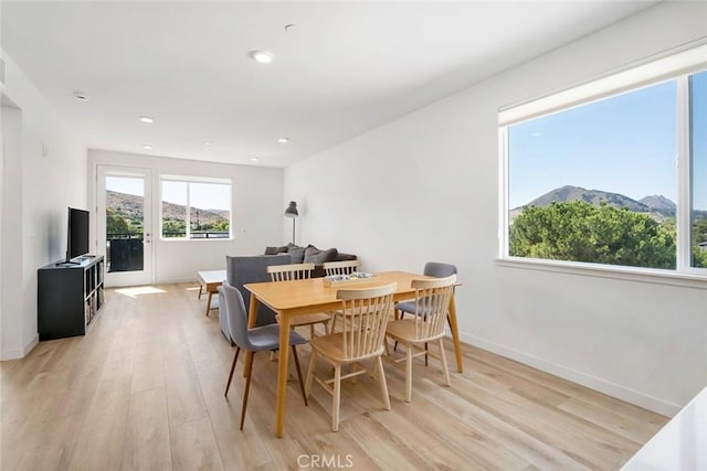 dining area featuring a mountain view and light wood-type flooring