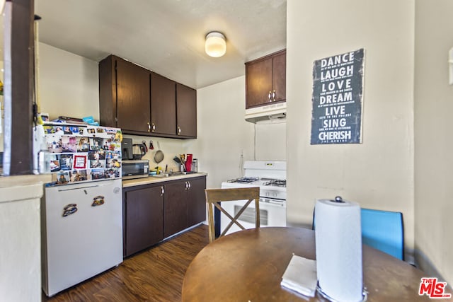 kitchen featuring dark brown cabinetry, dark hardwood / wood-style floors, white range with gas cooktop, and sink