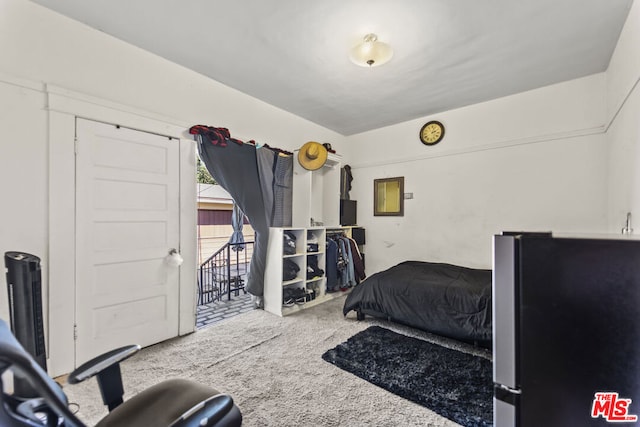 carpeted bedroom with stainless steel fridge