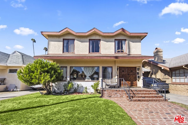 view of front of home featuring covered porch and a front yard