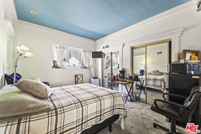 bedroom featuring crown molding and carpet flooring