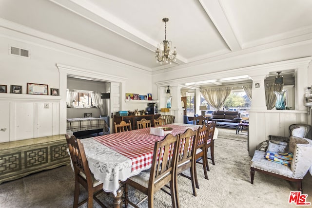 dining area with light carpet, beam ceiling, decorative columns, and a notable chandelier