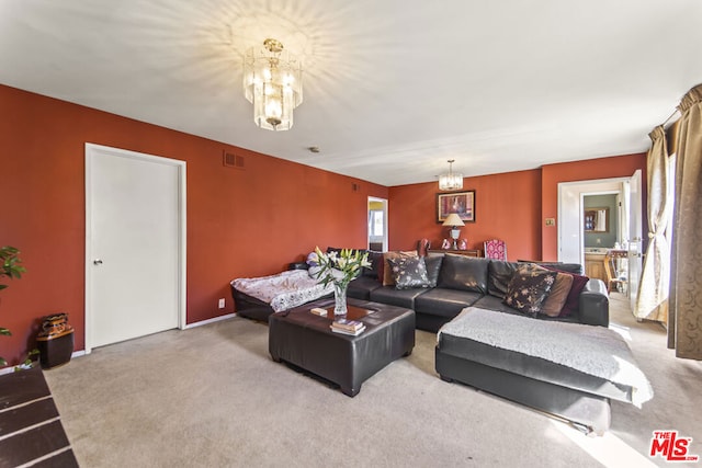 living room featuring a chandelier and carpet