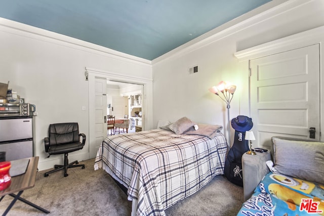 bedroom featuring crown molding and carpet flooring