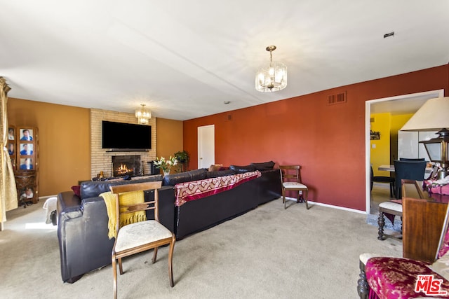 carpeted living room featuring a brick fireplace and a chandelier