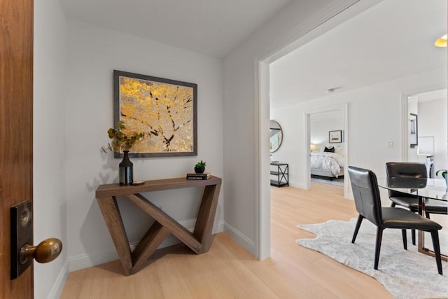 hallway with light hardwood / wood-style floors