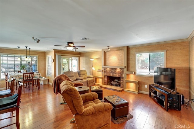 living room with ceiling fan, a healthy amount of sunlight, and wood-type flooring