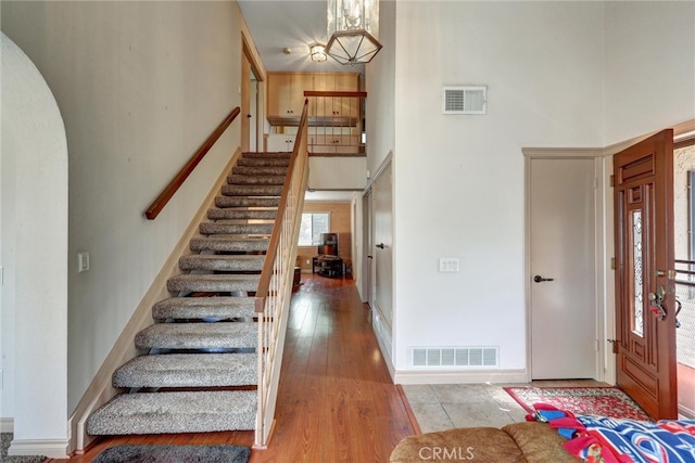 entryway with a high ceiling and wood-type flooring