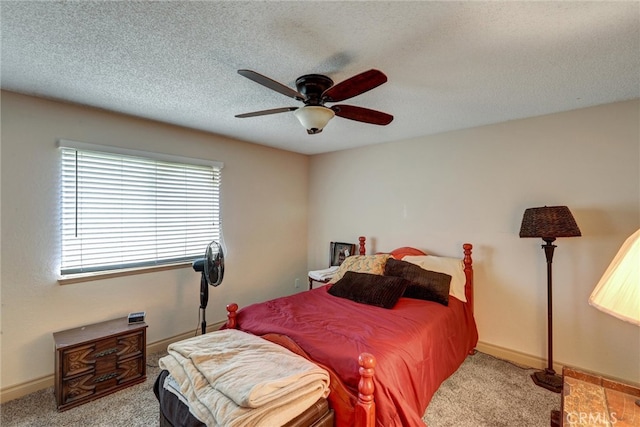 bedroom featuring ceiling fan, a textured ceiling, and carpet floors