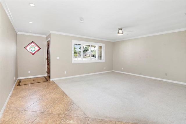 carpeted spare room featuring ceiling fan and crown molding