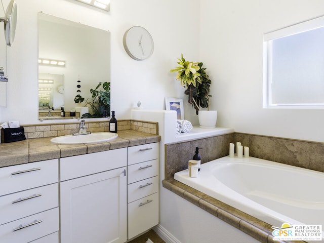 bathroom featuring vanity and a tub to relax in