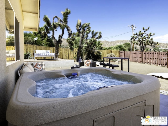 view of swimming pool with a patio and a hot tub