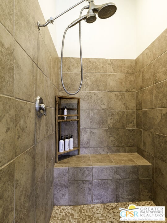 interior details featuring a tile shower