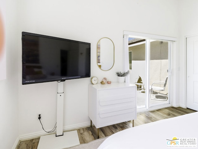 bedroom featuring hardwood / wood-style flooring and access to outside