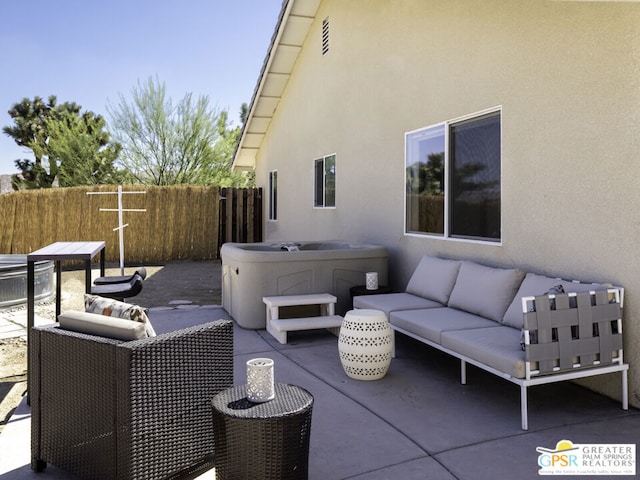 view of patio featuring a hot tub and an outdoor hangout area