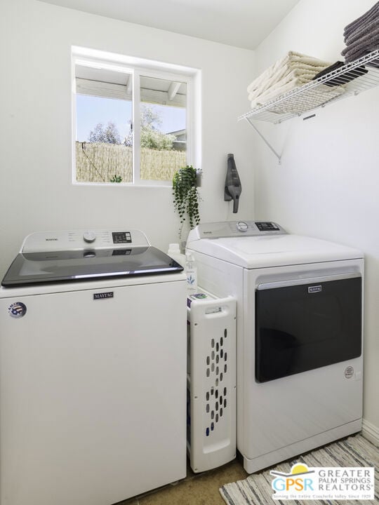 clothes washing area featuring washing machine and clothes dryer