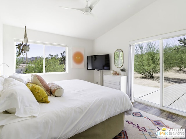 bedroom with multiple windows, access to exterior, and hardwood / wood-style flooring