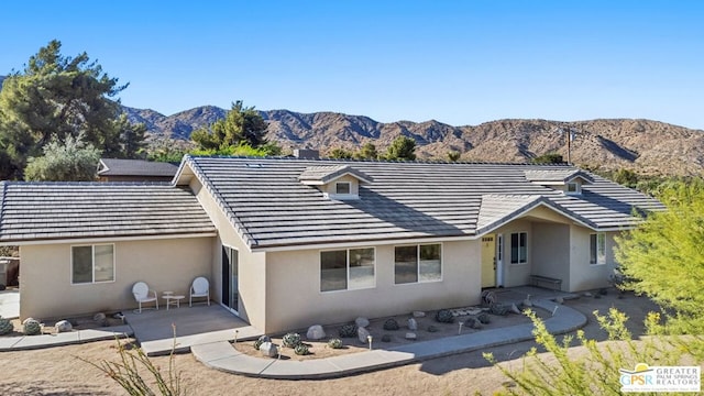 view of front of house featuring a patio and a mountain view