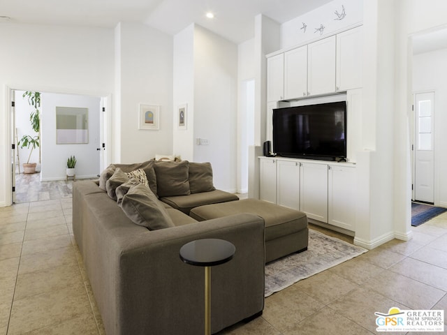 living room featuring light tile patterned floors and high vaulted ceiling