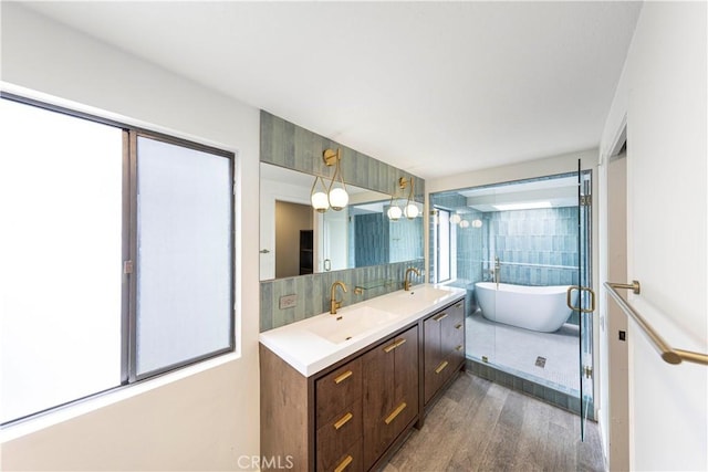 bathroom featuring vanity, a bath, and hardwood / wood-style flooring