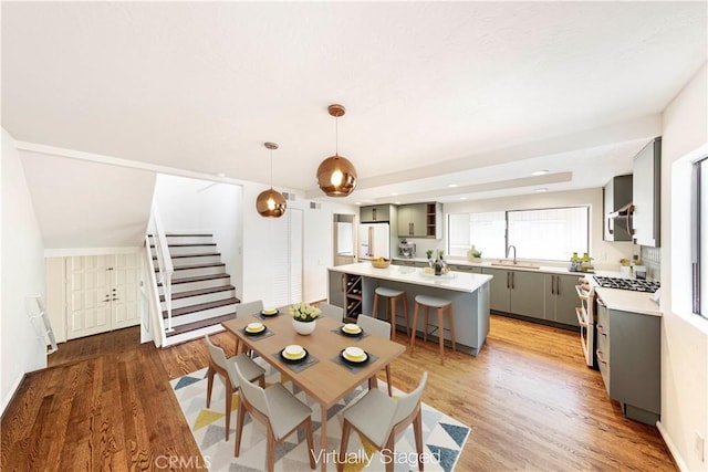 dining space featuring hardwood / wood-style flooring and sink