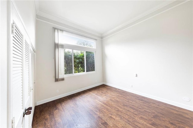 unfurnished room with crown molding and dark wood-type flooring