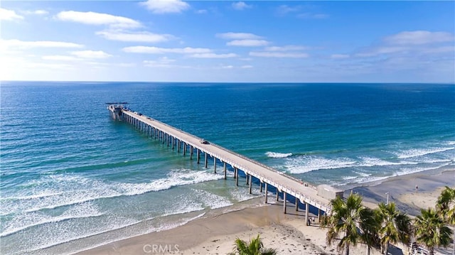 view of dock with a water view and a view of the beach