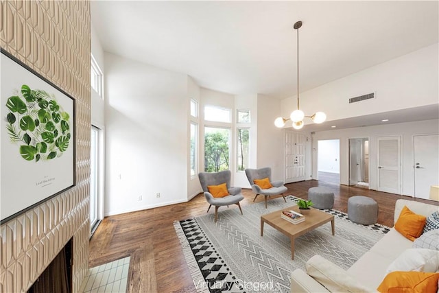 living room featuring a towering ceiling and an inviting chandelier