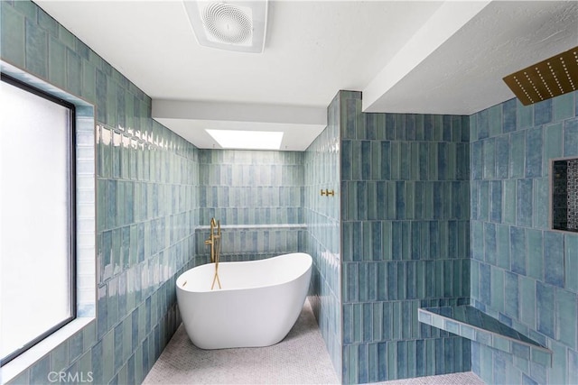 bathroom with separate shower and tub, tile walls, and a wealth of natural light