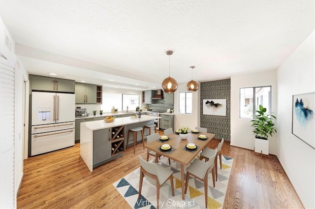 dining room with sink and light hardwood / wood-style floors