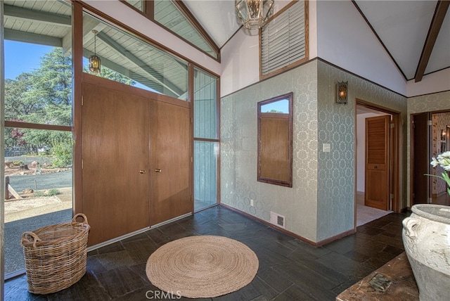 entrance foyer with beamed ceiling and high vaulted ceiling