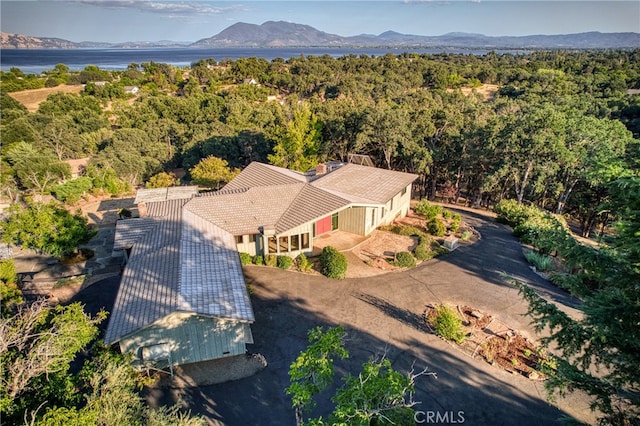 birds eye view of property with a water and mountain view