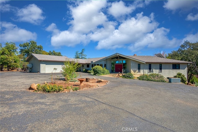 ranch-style house with central AC and a garage