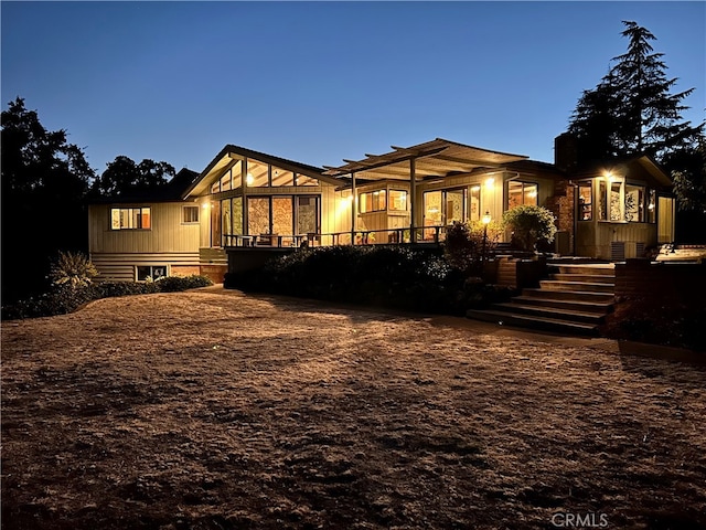 view of back house at dusk