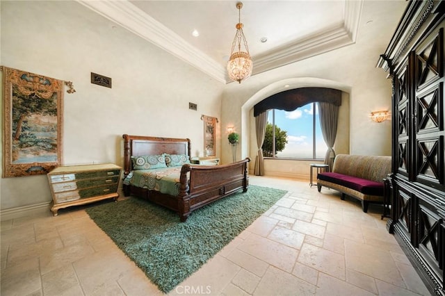 bedroom featuring a chandelier, a high ceiling, a tray ceiling, and ornamental molding