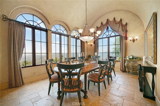 dining space featuring plenty of natural light, a chandelier, and vaulted ceiling