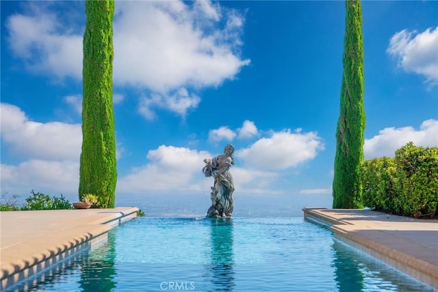 view of swimming pool with a water view