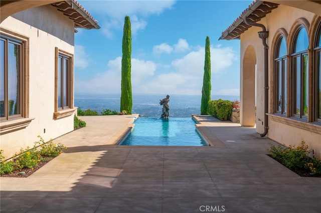 view of pool featuring a patio