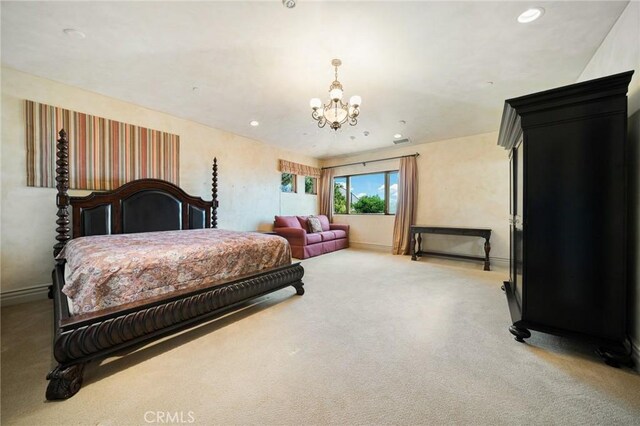 carpeted bedroom with an inviting chandelier