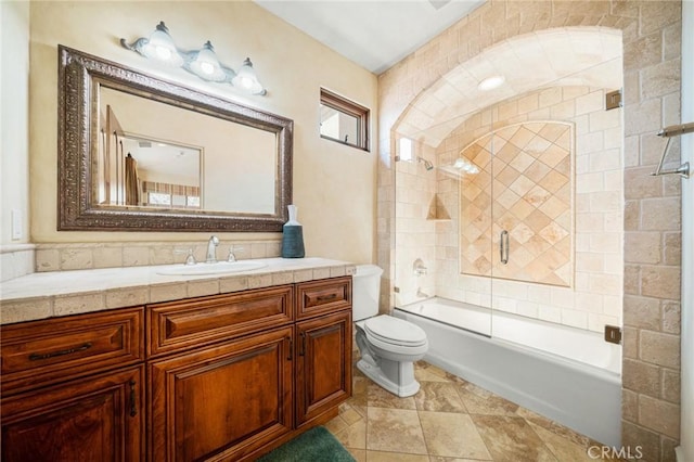 full bathroom with vanity, enclosed tub / shower combo, and toilet