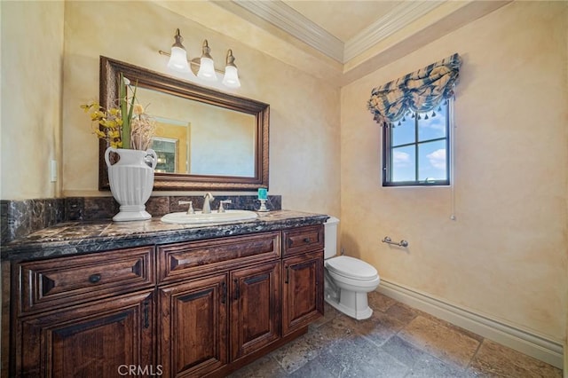 bathroom with vanity, toilet, and crown molding