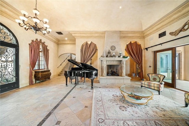 interior space featuring a fireplace, crown molding, and an inviting chandelier