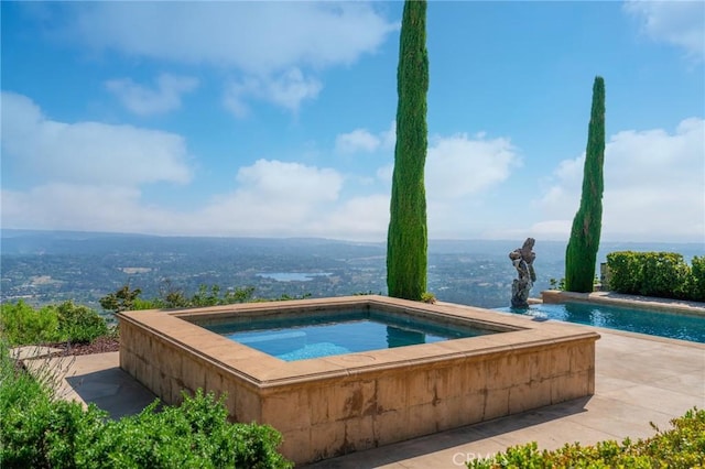 view of pool featuring an in ground hot tub