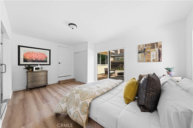 bedroom featuring light wood-type flooring and access to exterior