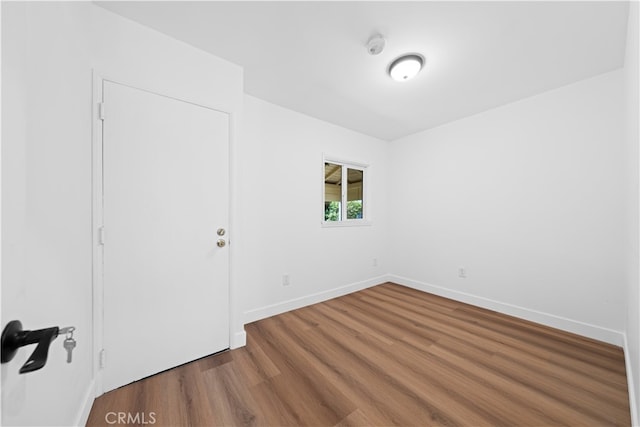 spare room with hardwood / wood-style flooring