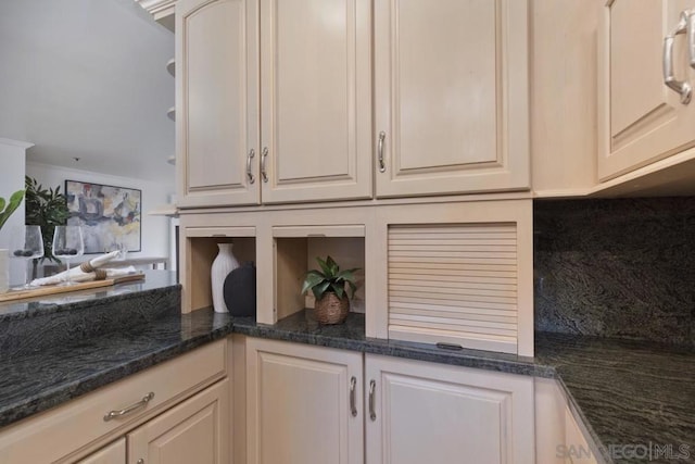 kitchen featuring tasteful backsplash and dark stone counters