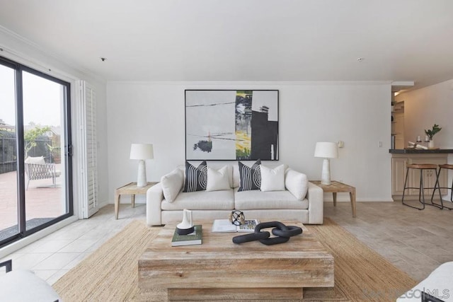 living room featuring light tile patterned floors and crown molding