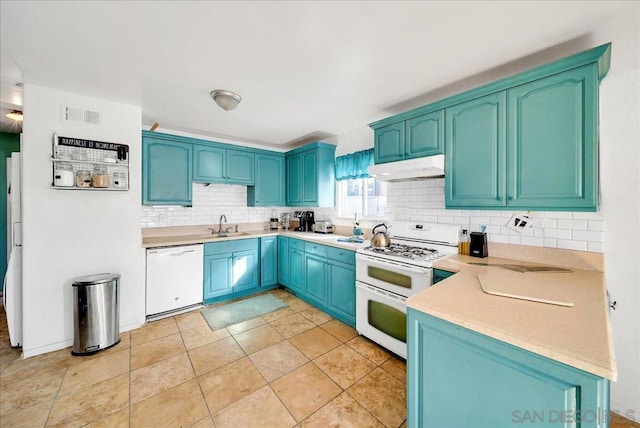 kitchen with white appliances, light tile patterned floors, tasteful backsplash, and sink