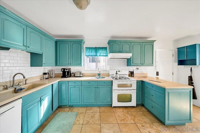 kitchen with kitchen peninsula, decorative backsplash, light tile patterned floors, sink, and white appliances