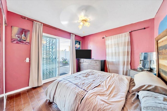 bedroom with ceiling fan, access to outside, and dark hardwood / wood-style floors